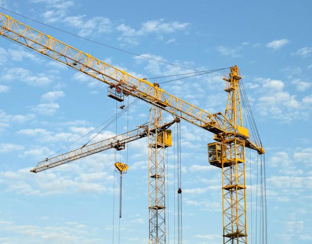 two cranes in blue sky